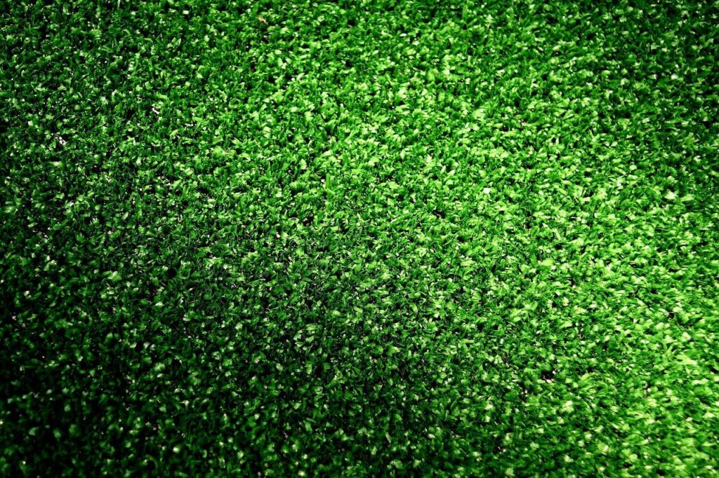 Kunstgras in een achtertuin met groen en strak gazon zonder onderhoud vereist